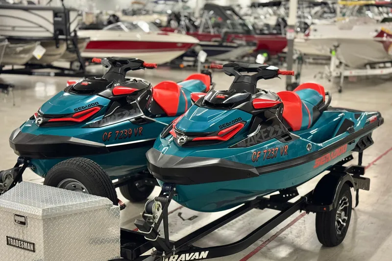 Slide: The Image of 2018 Sea-Doo Wake Pro 230 jet skis on trailer in showroom. - 2