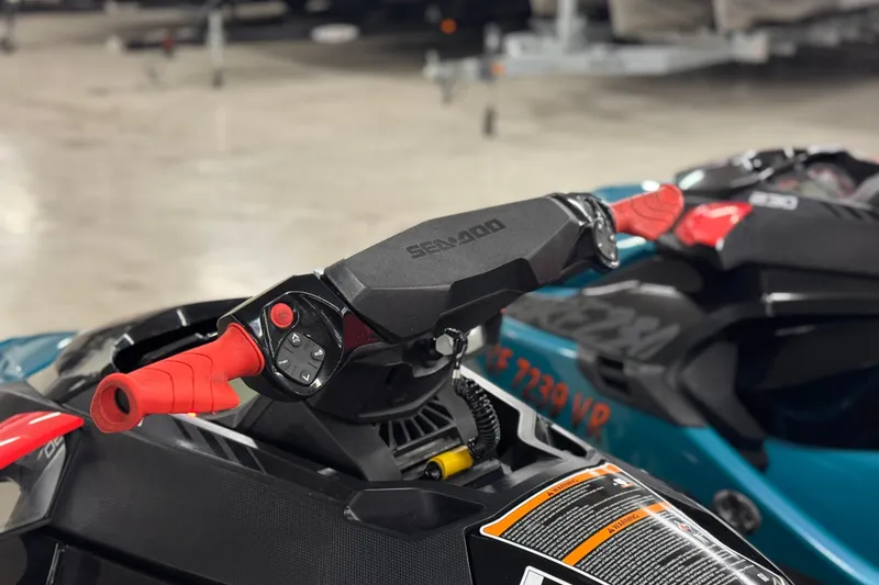 Slide: The Image of 2018 Sea-Doo Wake Pro 230 handlebars with red grips and control buttons. - 21