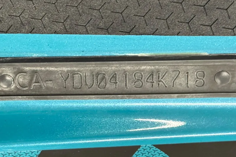 Slide: The Image of 2018 Sea-Doo Wake Pro 230 hull identification number on blue surface. - 26