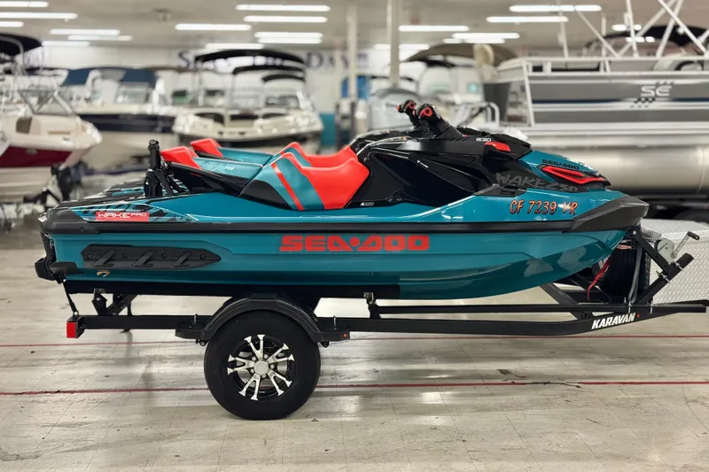 Slide: The Image of 2018 Sea-Doo Wake Pro 230 jet ski on trailer in showroom setting. - 4