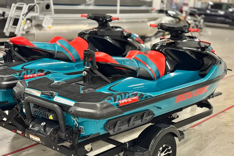 Slide: The Image of 2018 Sea-Doo Wake Pro 230 jet skis with vibrant red and teal design on trailer. - 5