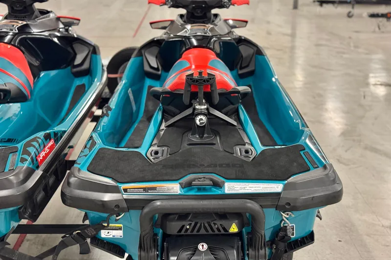 Slide: The Image of 2018 Sea-Doo Wake Pro 230 jet ski, vibrant blue and red design, rear view. - 6