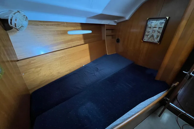 Slide: The Image of Cozy cabin interior of 1999 Beneteau First 42s7 sailboat with wooden paneling. - 16