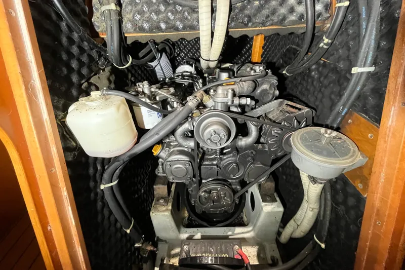 Slide: The Image of Engine compartment of a 1999 Beneteau First 42s7 sailboat, showcasing mechanical components. - 23