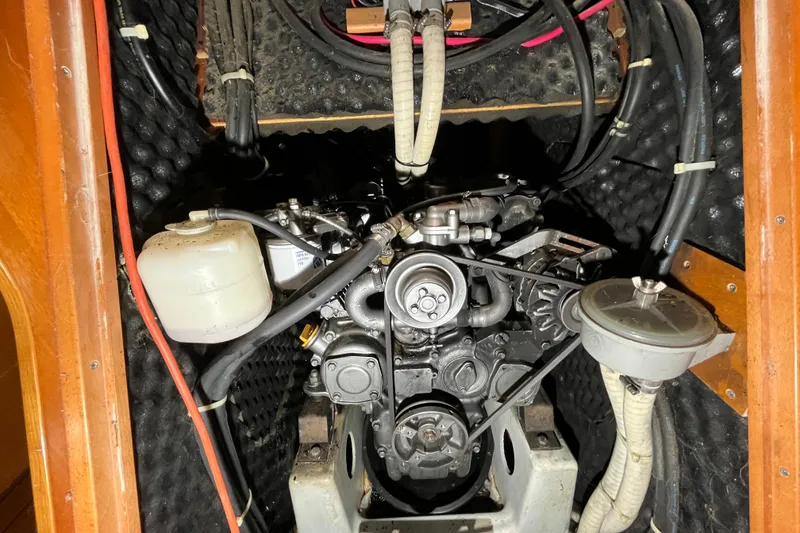 Slide: The Image of Engine compartment of a 1999 Beneteau First 42s7 sailboat, showcasing mechanical components. - 25