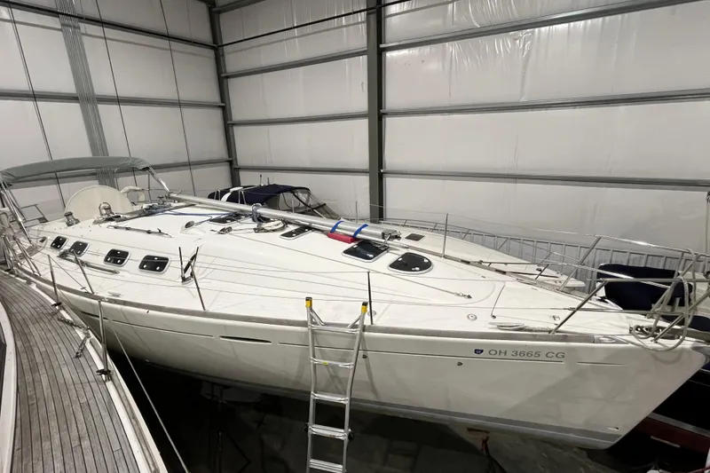 Slide: The Image of 1999 Beneteau First 42s7 sailboat in indoor storage, side view. - 26