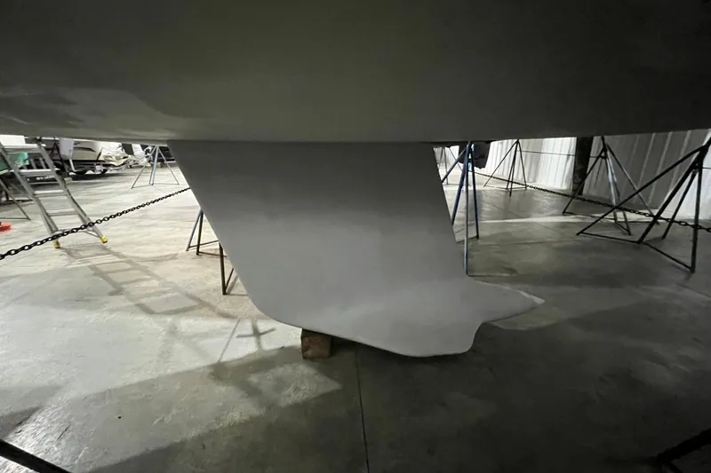 Slide: The Image of Keel of a 1999 Beneteau First 42s7 sailboat in a storage facility. - 7