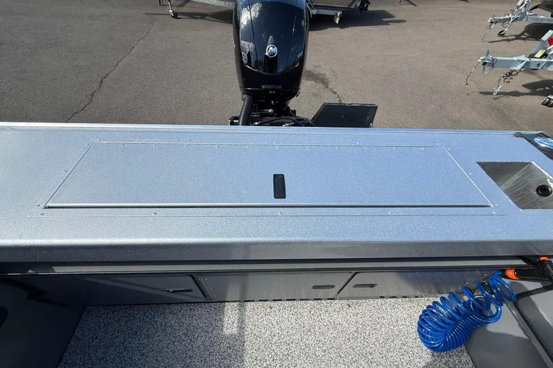 Slide: The Image of 2025 Alumaweld Stryker X202 boat deck with motor and storage compartments. - 15