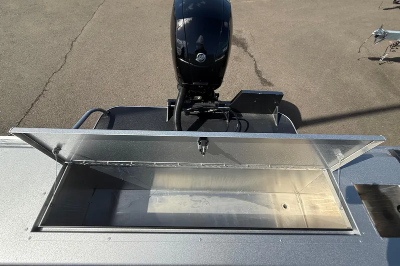 Slide: The Image of 2025 Alumaweld Stryker X202 boat with open storage compartment and motor. - 18