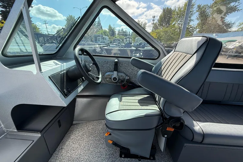 Slide: The Image of Interior of 2025 Alumaweld Stryker X202 boat with steering wheel and seating. - 19