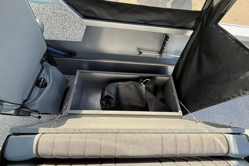Slide: The Image of Interior storage compartment of 2025 Alumaweld Stryker X202 boat with black bag. - 27