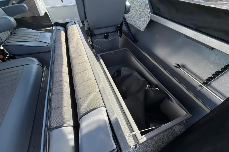 Slide: The Image of 2025 Alumaweld Stryker X202 boat interior with storage compartment and seating. - 28