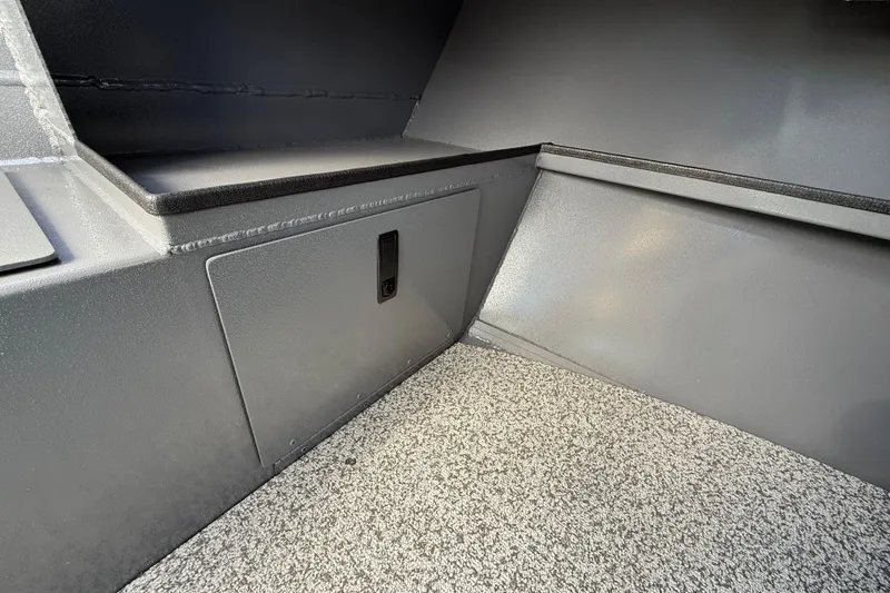 Slide: The Image of Interior of 2025 Alumaweld Stryker X202 boat, featuring storage compartment and textured flooring. - 33