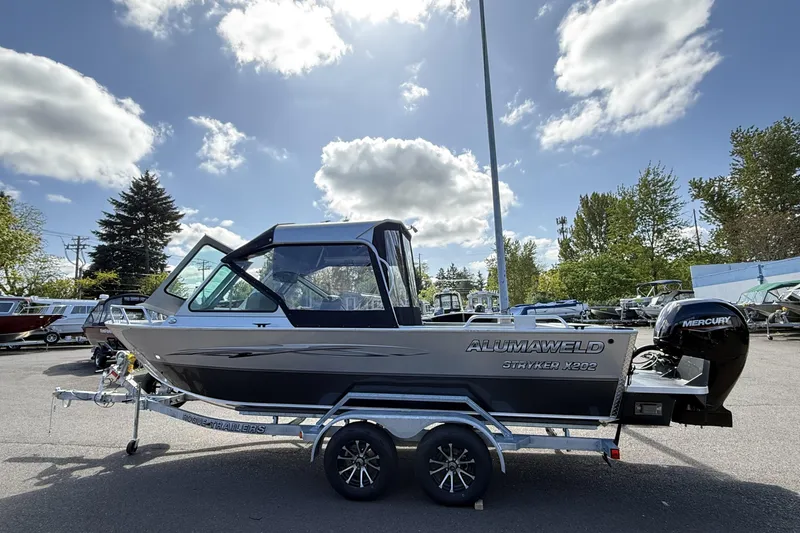 Slide: The Image of 2025 Alumaweld Stryker X202 boat on trailer under a partly cloudy sky. - 4