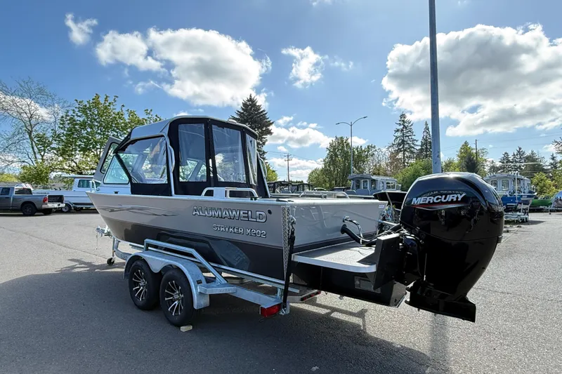 Slide: The Image of 2025 Alumaweld Stryker X202 boat with Mercury engine on trailer in parking lot. - 5
