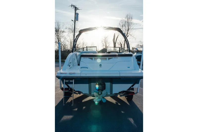 Slide: The Image of 2023 Sea Ray SPX 230 boat rear view with sunlit background. - 2