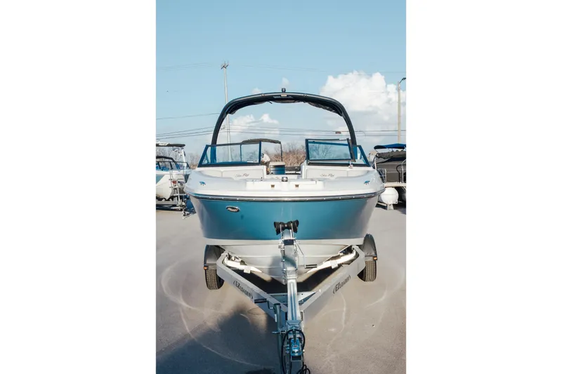 Slide: The Image of 2023 Sea Ray SPX 230 boat on trailer, front view under clear sky. - 3