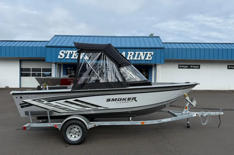 The Image of 2025 Smoker Craft Osprey 162 boat on trailer outside marine store. - 1