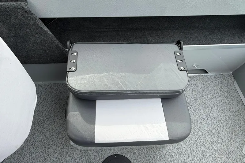 Slide: The Image of 2025 Smoker Craft Osprey 162 boat seat with gray upholstery and metal hinges. - 11