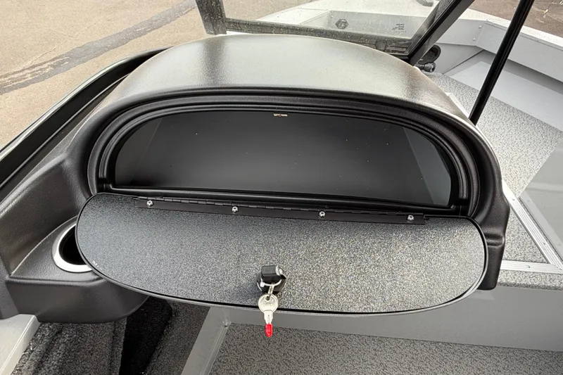 Slide: The Image of 2025 Smoker Craft Osprey 162 boat dashboard with open glove compartment and key. - 14