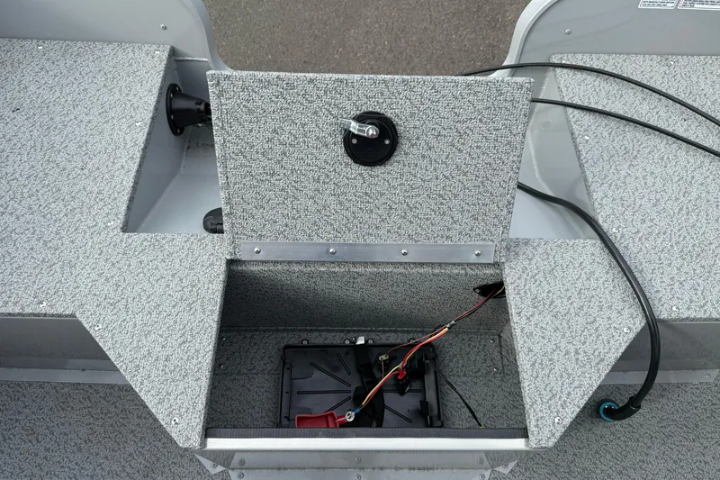 Slide: The Image of 2025 Smoker Craft Osprey 162 boat interior with open storage compartment and wiring. - 18