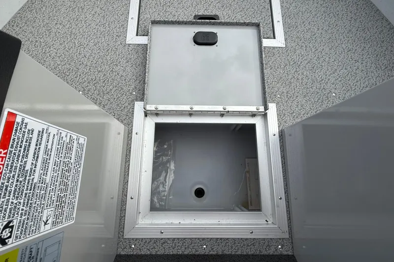 Slide: The Image of 2025 Smoker Craft Osprey 162 boat storage compartment with open hatch. - 25
