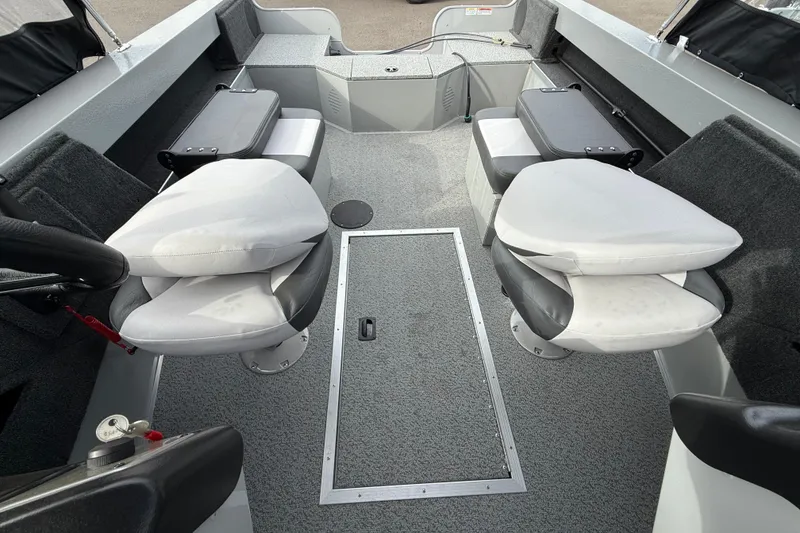 Slide: The Image of 2025 Smoker Craft Osprey 162 boat interior with swivel seats and storage compartments. - 3