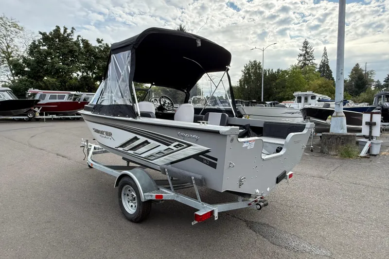 Slide: The Image of 2025 Smoker Craft Osprey 162 boat on trailer, parked outdoors under cloudy sky. - 30