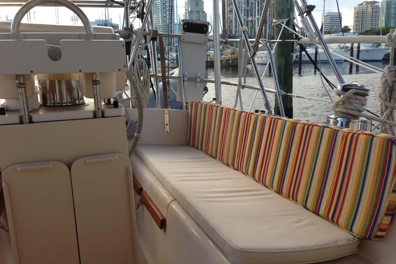 Slide: The Image of Cozy seating area on a 1995 Island Packet 37 sailboat with colorful striped cushions. - 16
