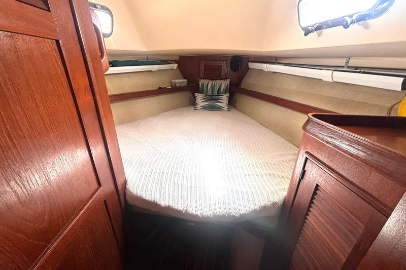 Slide: The Image of Cozy cabin interior of 1995 Island Packet 37 sailboat with wooden finishes. - 6