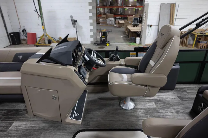Slide: The Image of Manufacturer Provided Image: 2024 Viaggio Lago X-S boat interior with captain's chair and control console in a workshop. - 12