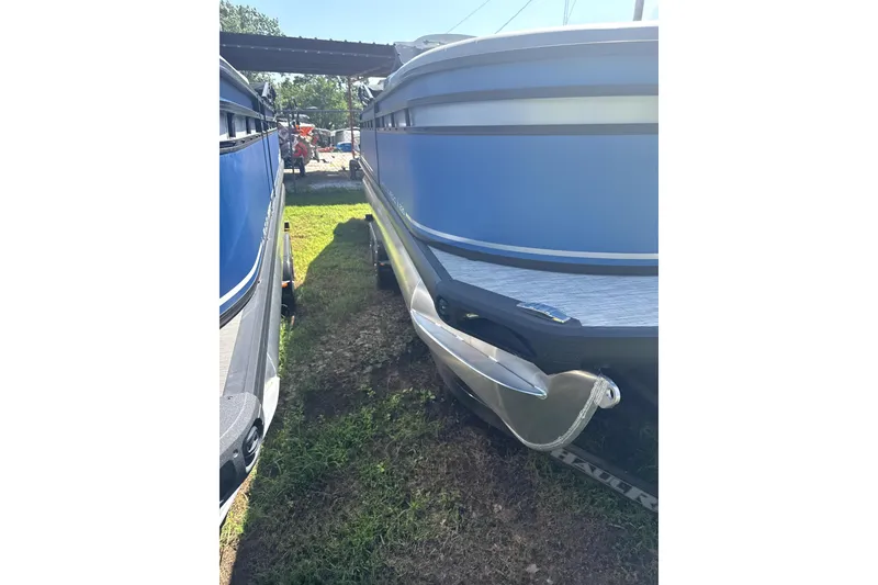 Slide: The Image of 2024 Viaggio Lago X-S boat, blue exterior, parked on grass, side view. - 3