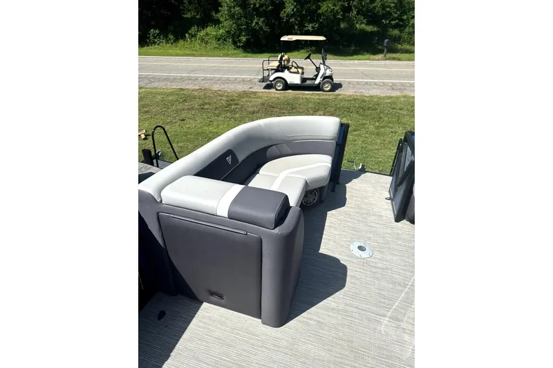 Slide: The Image of 2024 Viaggio Lago X-S boat interior with plush seating, parked near a golf cart. - 8