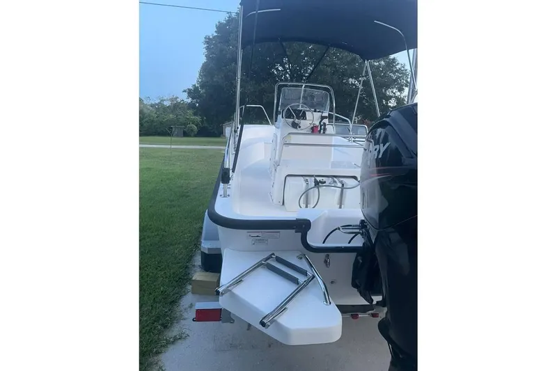 Slide: The Image of 2015 Boston Whaler 170 Montauk boat with Mercury engine and bimini top. - 10