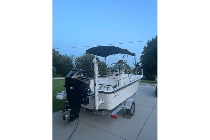 Slide: The Image of 2015 Boston Whaler 170 Montauk boat with Mercury engine on trailer. - 2