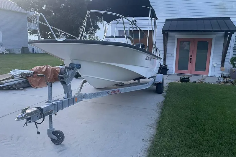 Slide: The Image of 2015 Boston Whaler 170 Montauk boat on trailer in driveway. - 4