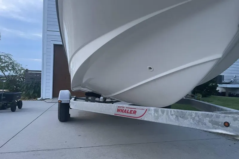 Slide: The Image of 2015 Boston Whaler 170 Montauk boat on trailer in driveway. - 6