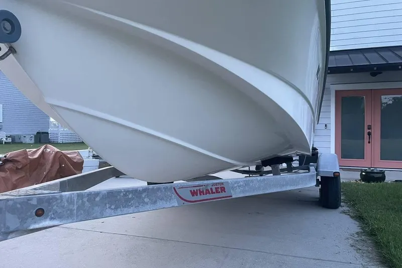 Slide: The Image of 2015 Boston Whaler 170 Montauk boat on trailer, parked in driveway. - 7
