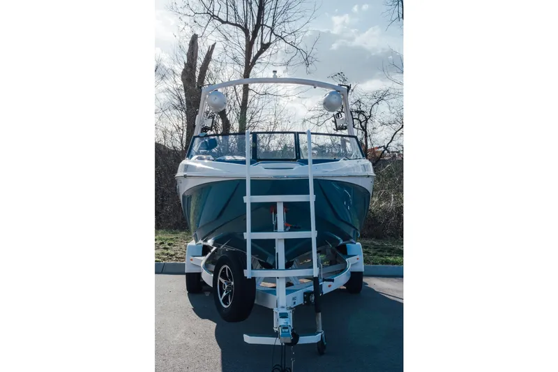 Slide: The Image of 2022 Tigé Z1 boat on trailer, parked outdoors with trees in background. - 3