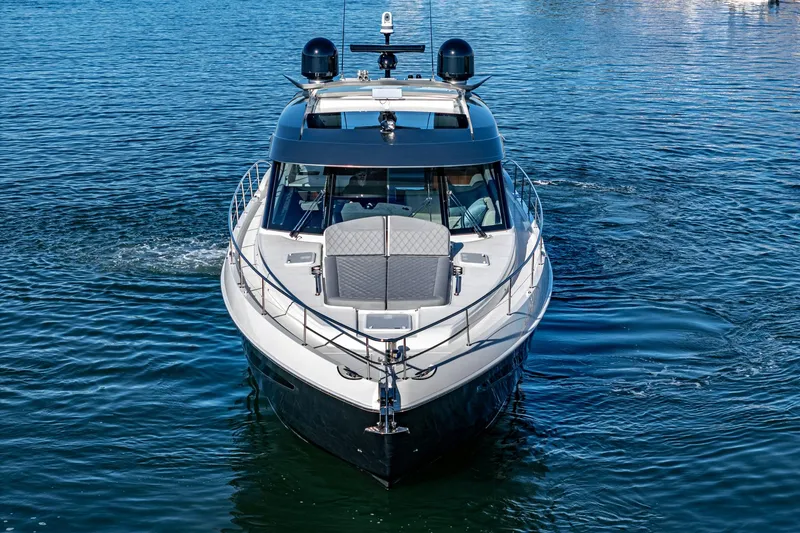 Slide: The Image of 2024 Riviera 5400 Sport Yacht on water, front view. - 14