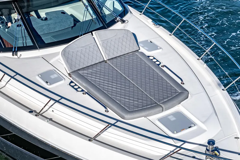 Slide: The Image of 2024 Riviera 5400 Sport Yacht sun deck with cushioned seating. - 15