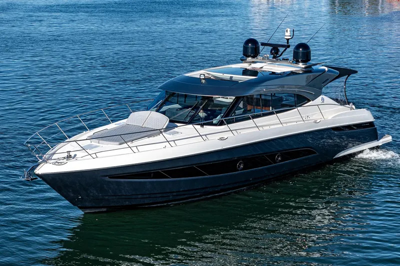 Slide: The Image of 2024 Riviera 5400 Sport Yacht cruising on water. - 2