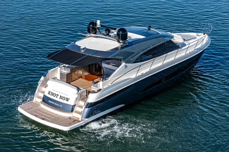 Slide: The Image of 2024 Riviera 5400 Sport Yacht cruising on the water. - 3