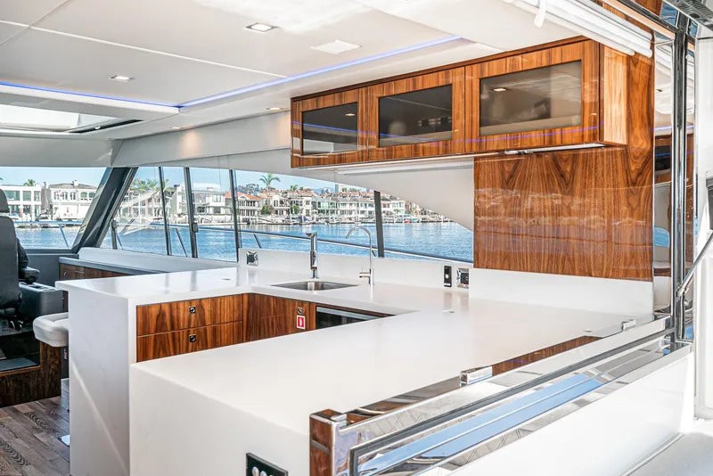 Slide: The Image of Luxurious interior of the 2024 Riviera 5400 Sport Yacht with modern kitchen and waterfront view. - 37