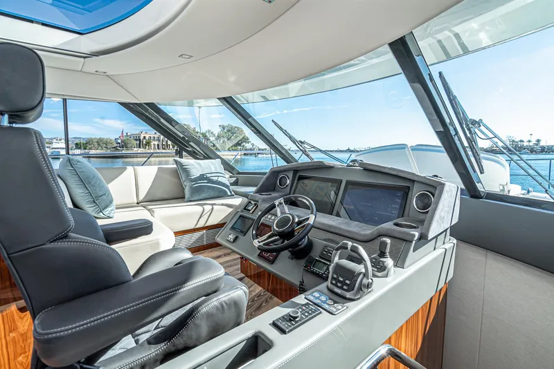 Slide: The Image of Interior of 2024 Riviera 5400 Sport Yacht with modern helm and luxurious seating. - 41