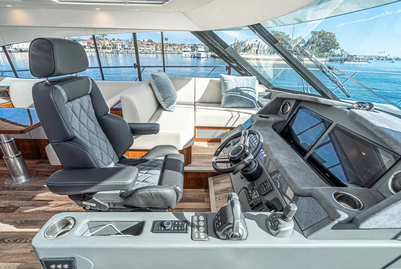 Slide: The Image of 2024 Riviera 5400 Sport Yacht helm with luxurious seating and advanced navigation systems. - 42