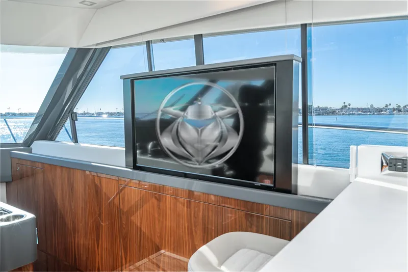 Slide: The Image of Interior of 2024 Riviera 5400 Sport Yacht with TV and ocean view. - 43