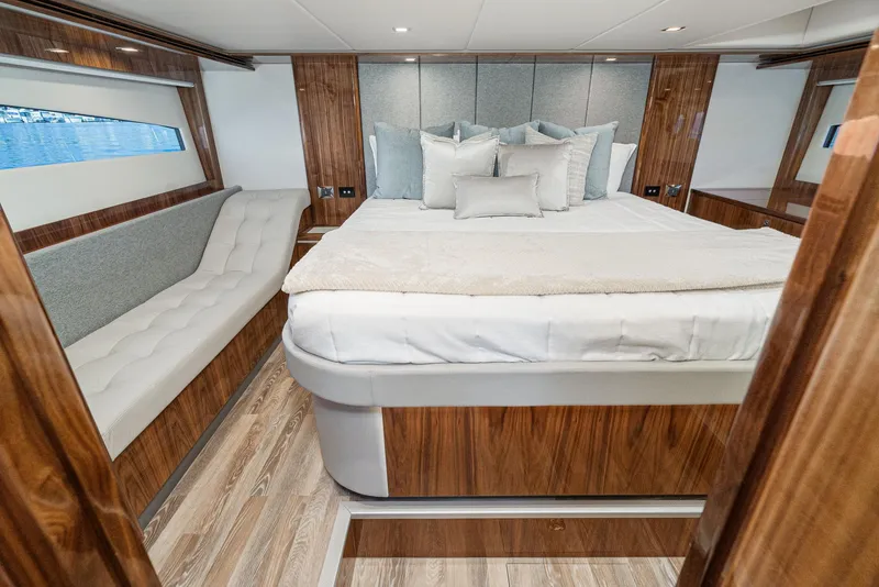 Slide: The Image of Luxurious bedroom in the 2024 Riviera 5400 Sport Yacht with modern decor and wood finishes. - 48