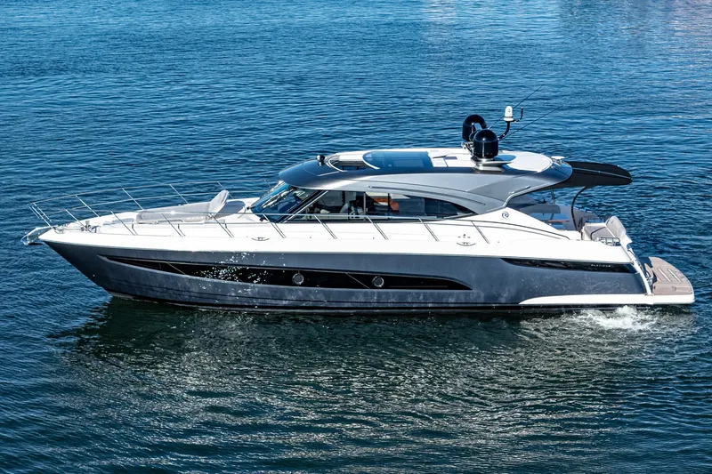 Slide: The Image of 2024 Riviera 5400 Sport Yacht cruising on open water. - 5