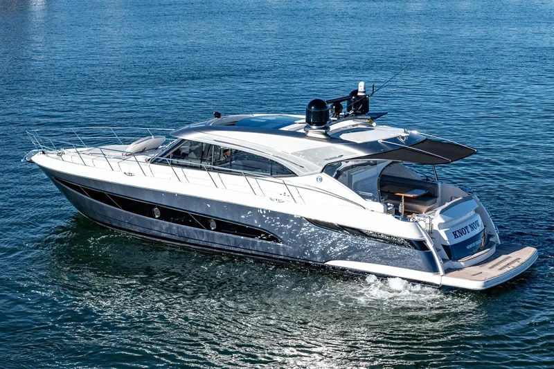 Slide: The Image of 2024 Riviera 5400 Sport Yacht cruising on the water. - 6